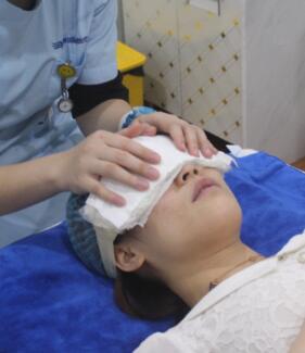 去眼袋術(shù)后護(hù)士給我做冰敷，防止淤青加快恢復(fù)